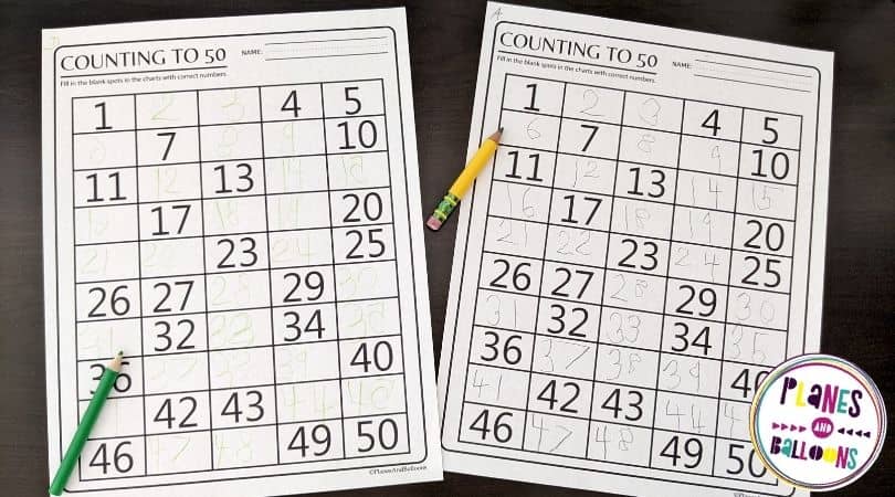 1-50 number charts on desk with pencils