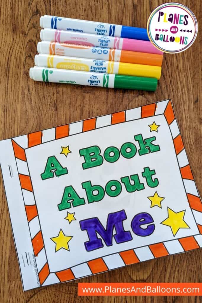 All about me booklet front page colored placed on wooden floor with markers